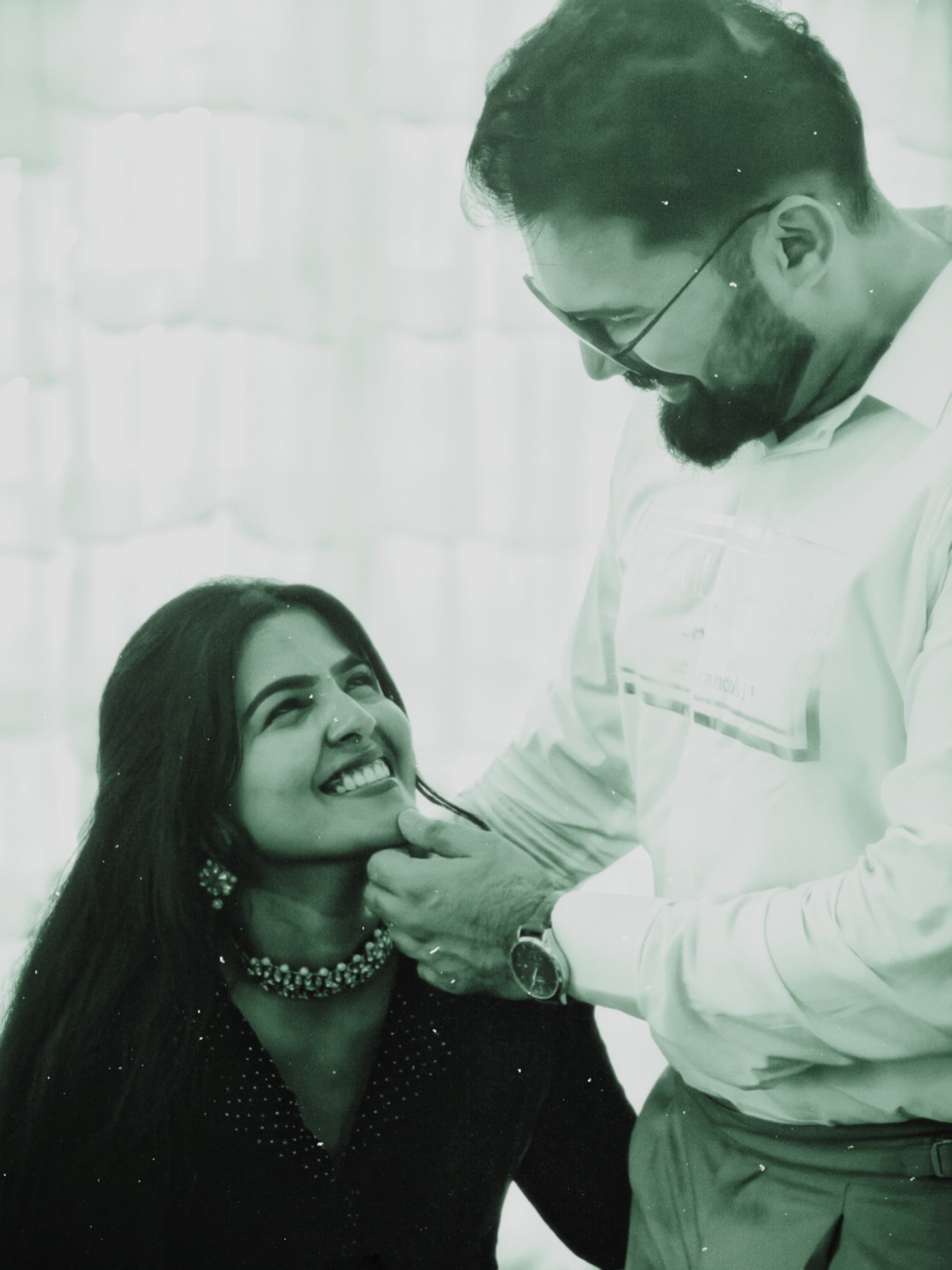 Stylized green-tinted candid of the couple sharing a tender moment